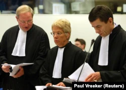 Prosecutors Dirk Ryneveld (left), Carla del Ponte (center), and Geoffrey Nice prepare for the the second day of the trial of former Serbian President Slobodan Milosevic in The Hague on February 13, 2002.