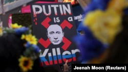 A person holds a placard during a rally and protest against Russia's invasion of Ukraine in New York City on April 9.