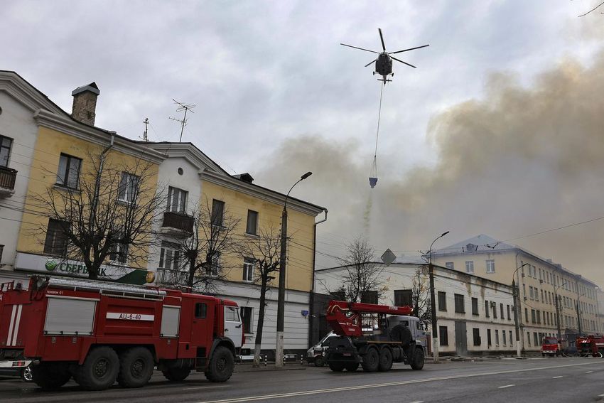 A helicopter dumps water onto the burning building of the Central Research Institute of the Aerospace Defense Forces in Tver, Russia on April 21, 2022, fighting a fire that would kill 22 people. The blaze was officially blamed on faulty wiring, but many suspect sabotage.